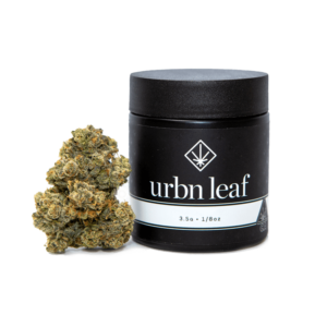A black jar labeled "urbn leaf" with a cannabis leaf icon, part of the 2022 Holiday Favorites, stands next to a cannabis bud; the label indicates 3.5g or 1/8oz. Urbn-Leaf-Sativa-Top-Shelf-Cannabis-Flower