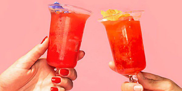 Two Hands Toasting with Cocktail Glasses