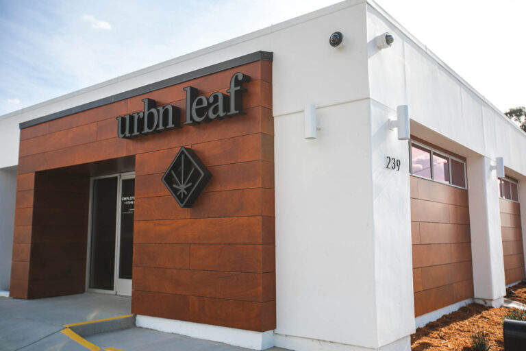 Grover-Beach-2jpg - Harborside Exterior view of a modern building with a sign that reads "urbn leaf" and the address number 239 visible on the side wall. Grover-Beach-2jpg
