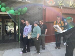 A line of eager Harborside customers waiting outside to get in at the Harborside storefront at opening Image 16