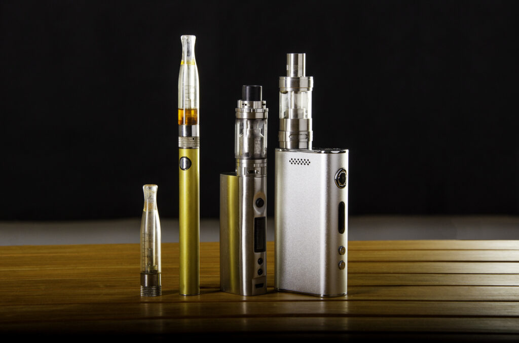 vape devices and electronic cigarette ecig and mods over a black background