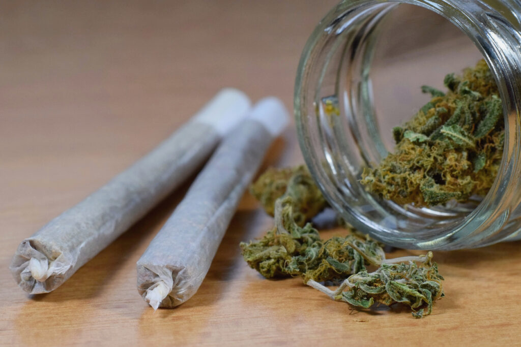 Marijuana buds jar and joints on the table